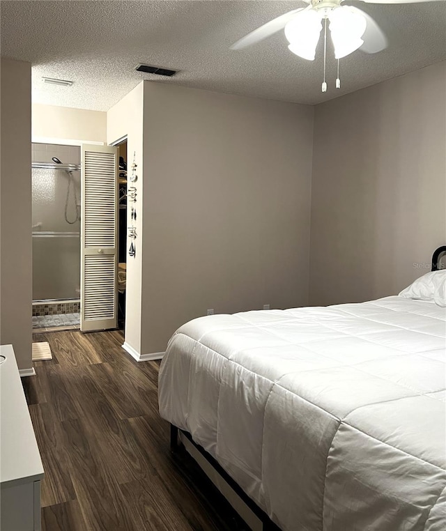 7721 Hillside Ct Unit 203, Hudson, FL 34667 - bedroom with dark wood-type flooring, a textured ceiling, a ceiling fan, and a closet