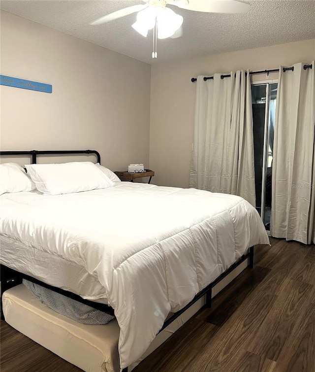 7721 Hillside Ct Unit 203, Hudson, FL 34667 - bedroom featuring wood finished floors, a ceiling fan, and a textured ceiling