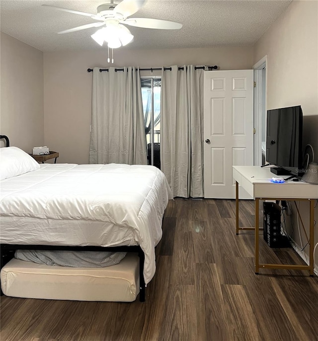 7721 Hillside Ct Unit 203, Hudson, FL 34667 - bedroom featuring dark wood-style floors, a textured ceiling, and ceiling fan