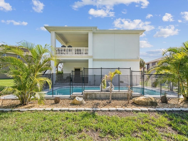 5621 Egrets Pl, New Port Richey, FL 34652 - rear view of house featuring a balcony and stucco siding