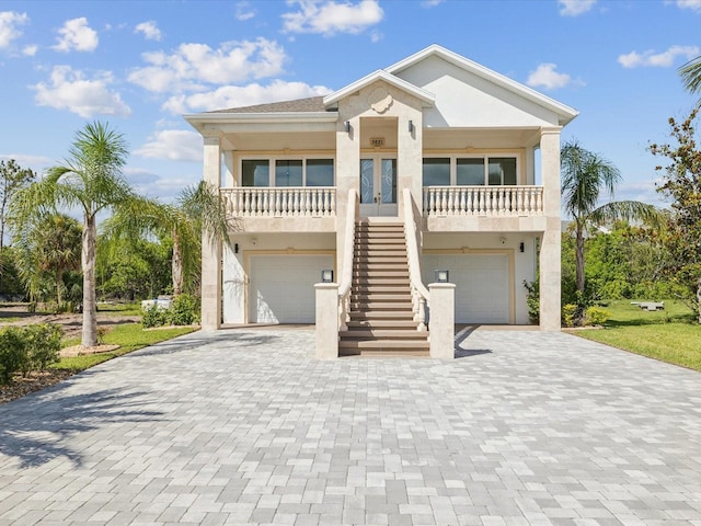 5621 Egrets Pl, New Port Richey, FL 34652 - coastal home with stairway, stucco siding, french doors, and a garage
