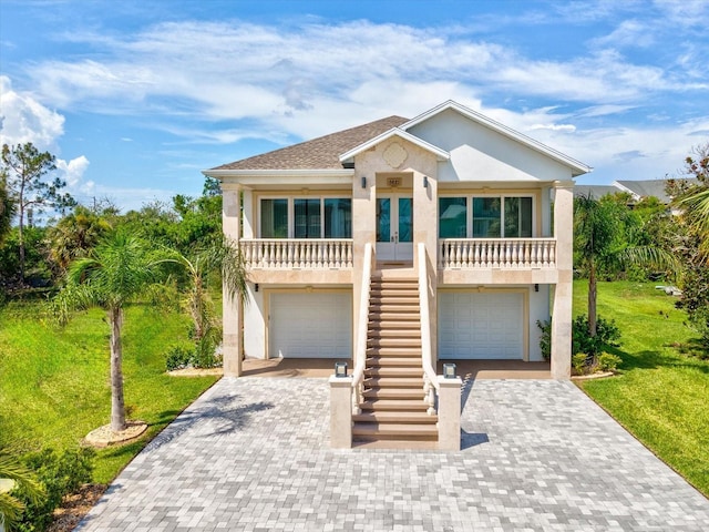 5621 Egrets Pl, New Port Richey, FL 34652 - view of front of house featuring stairs, a front lawn, decorative driveway, and an attached garage