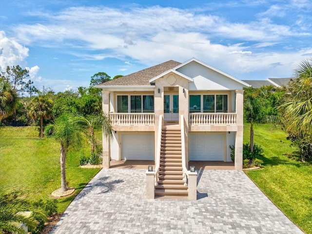 5621 Egrets Pl, New Port Richey, FL 34652 - beach home with stairway, stucco siding, french doors, and a front lawn