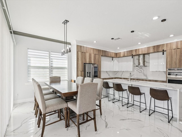 5621 Egrets Pl, New Port Richey, FL 34652 - dining space with light marble finish floors, crown molding, recessed lighting, and a chandelier