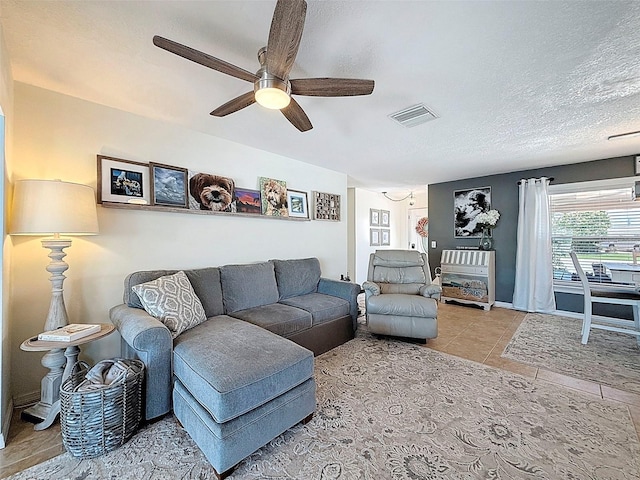 12817 2nd Isle, Hudson, FL 34667 - tiled living area with a ceiling fan and a textured ceiling