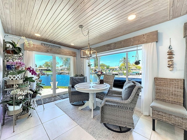 12817 2nd Isle, Hudson, FL 34667 - dining room featuring wooden ceiling, tile patterned flooring, a chandelier, a water view, and recessed lighting