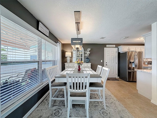 12817 2nd Isle, Hudson, FL 34667 - dining space with light tile patterned floors and a textured ceiling