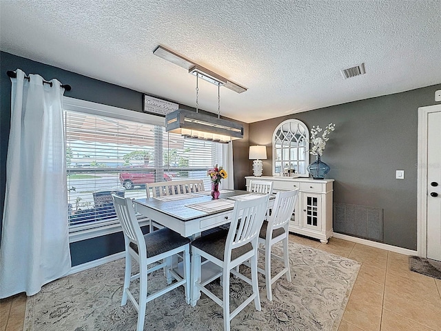 12817 2nd Isle, Hudson, FL 34667 - dining room featuring plenty of natural light, a textured ceiling, and light tile patterned floors