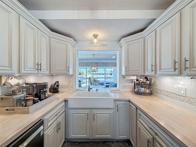 12817 2nd Isle, Hudson, FL 34667 - kitchen with backsplash, light countertops, white cabinetry, and a textured ceiling