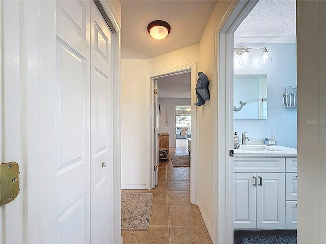 12817 2nd Isle, Hudson, FL 34667 - hallway featuring light tile patterned floors and a textured ceiling