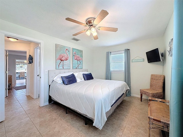 12817 2nd Isle, Hudson, FL 34667 - bedroom with light tile patterned floors and a ceiling fan