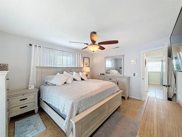 12817 2nd Isle, Hudson, FL 34667 - bedroom with light tile patterned floors, multiple windows, and ceiling fan