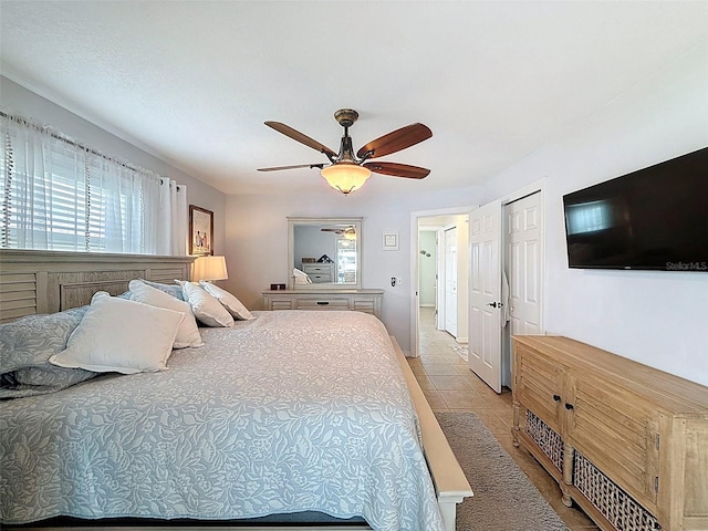 12817 2nd Isle, Hudson, FL 34667 - bedroom with light tile patterned floors and a ceiling fan