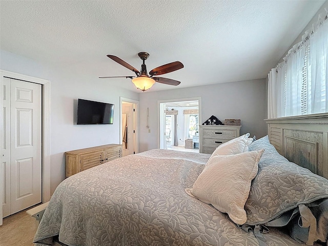 12817 2nd Isle, Hudson, FL 34667 - bedroom with a ceiling fan, a textured ceiling, and light colored carpet