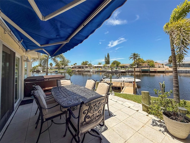 12817 2nd Isle, Hudson, FL 34667 - view of patio with a hot tub, a water view, and a boat dock