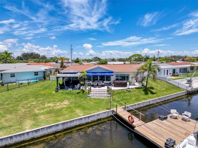 12817 2nd Isle, Hudson, FL 34667 - dock area with a water view, a hot tub, a fenced backyard, a patio, and a gazebo