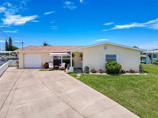 12817 2nd Isle, Hudson, FL 34667 - ranch-style house with stucco siding, concrete driveway, an attached garage, a front yard, and roof with shingles