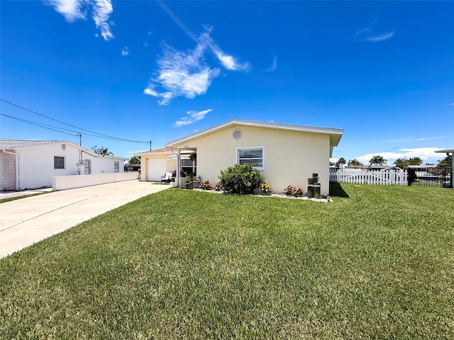 12817 2nd Isle, Hudson, FL 34667 - back of house featuring concrete driveway, stucco siding, and a garage