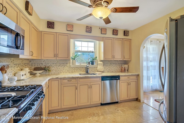 38 Sweet Gum Rd, Howell, NJ 07731 - kitchen with stainless steel appliances, arched walkways, backsplash, ceiling fan, and cream cabinets