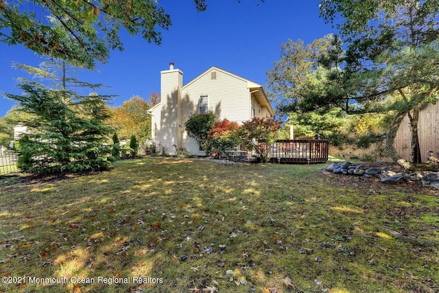 38 Sweet Gum Rd, Howell, NJ 07731 - view of home's exterior featuring a chimney and a wooden deck