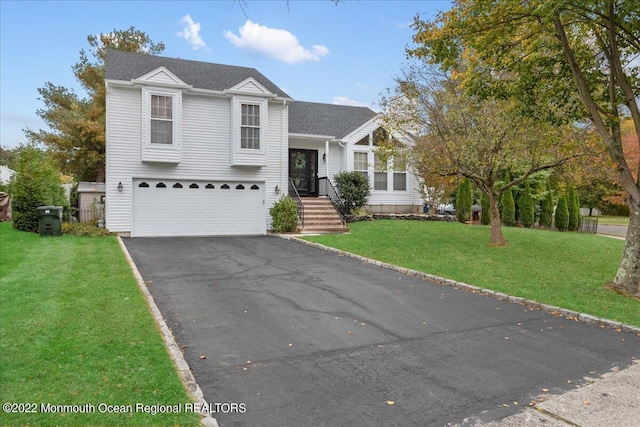 38 Sweet Gum Rd, Howell, NJ 07731 - tri-level home featuring asphalt driveway, an attached garage, and a front yard