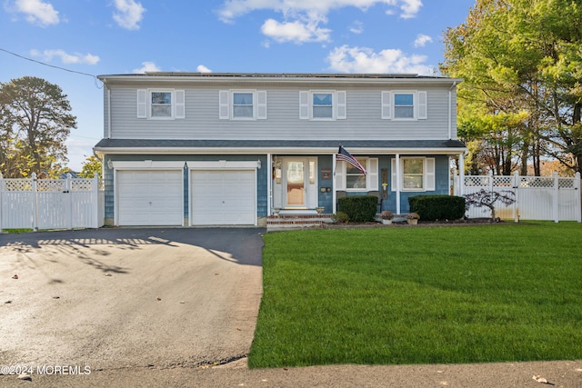 front facade with a garage and a front yard