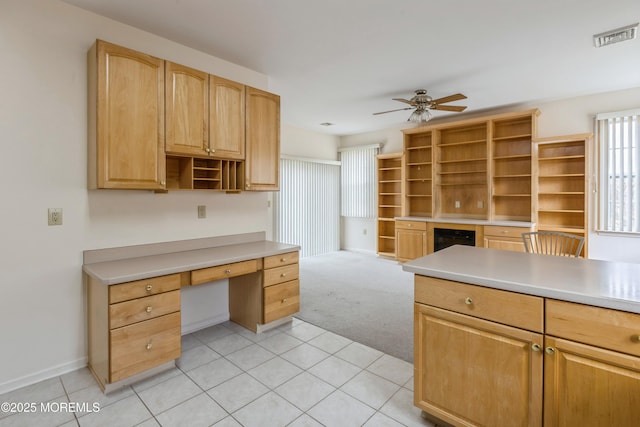 kitchen with visible vents, a ceiling fan, light countertops, open shelves, and built in desk