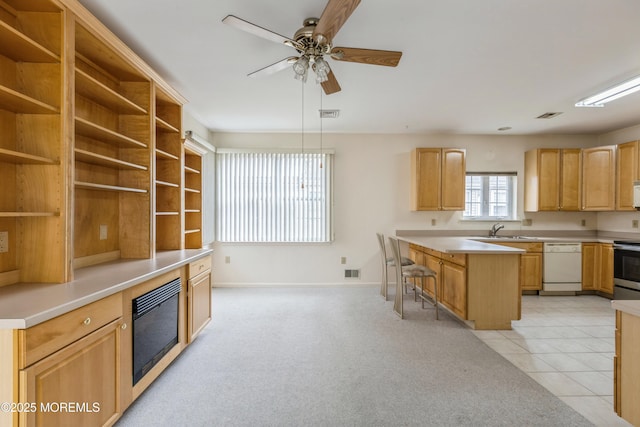 kitchen with open shelves, visible vents, a sink, white appliances, and a kitchen breakfast bar