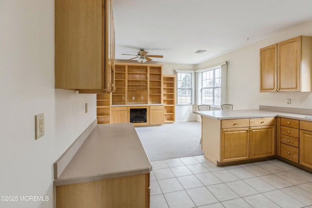 kitchen featuring ceiling fan, beverage cooler, a peninsula, visible vents, and light countertops