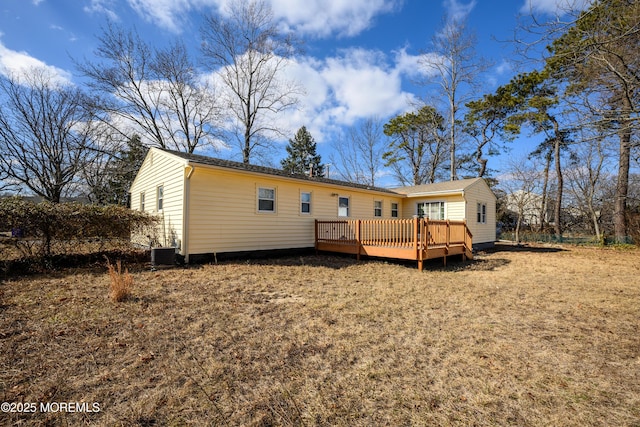 rear view of house featuring a wooden deck and central AC unit