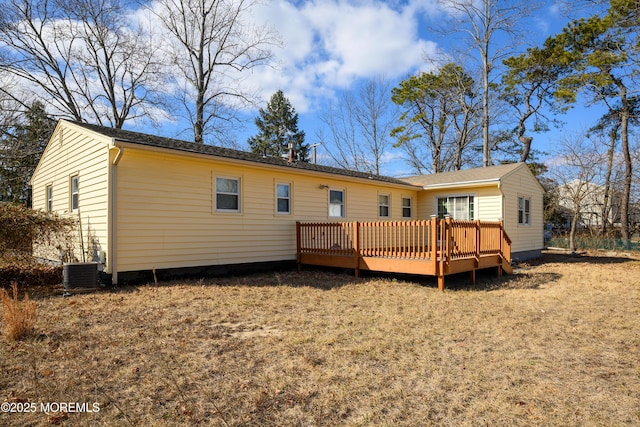 back of house featuring central AC and a deck