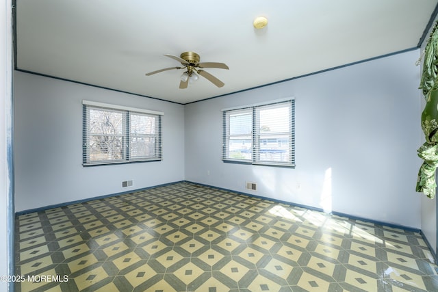 unfurnished room with a healthy amount of sunlight and ceiling fan