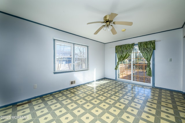 spare room featuring ceiling fan and a wealth of natural light