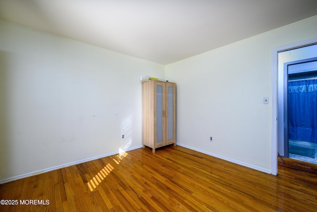 spare room with dark hardwood / wood-style floors