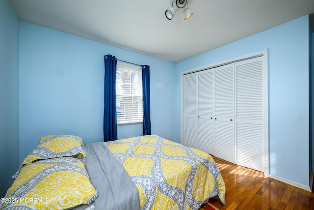 bedroom featuring dark hardwood / wood-style floors and a closet