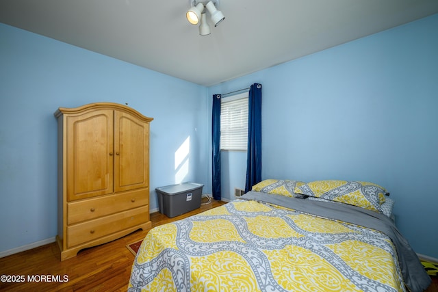 bedroom featuring dark hardwood / wood-style flooring