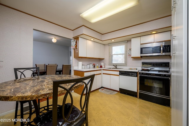 kitchen featuring crown molding, white dishwasher, black gas stove, and white cabinets