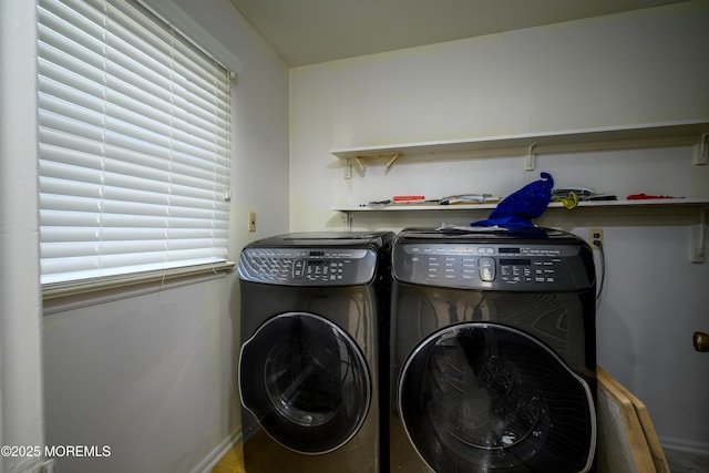 laundry room with washing machine and dryer and a wealth of natural light