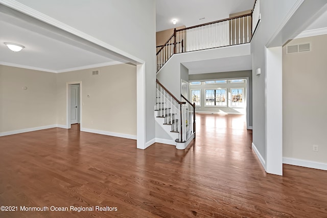 interior space with dark hardwood / wood-style flooring and ornamental molding