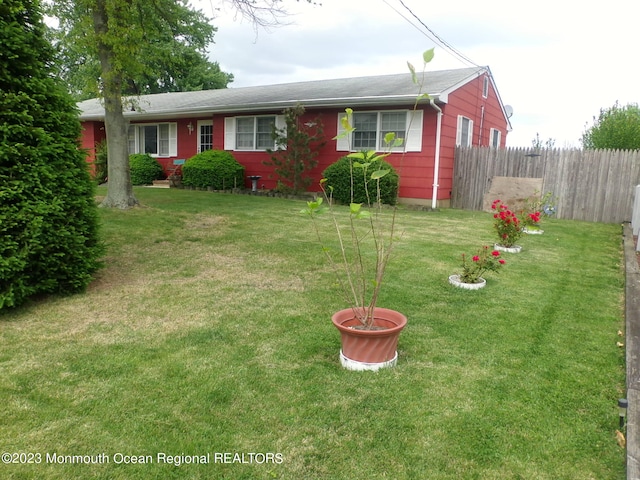 ranch-style home with a front lawn