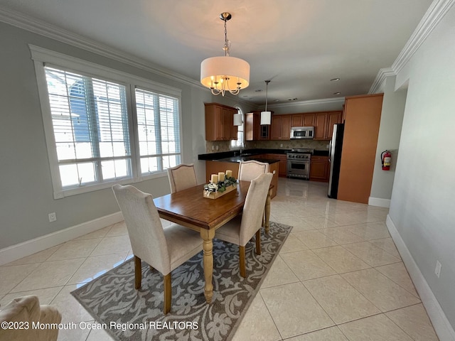 tiled dining room with a notable chandelier, sink, and ornamental molding