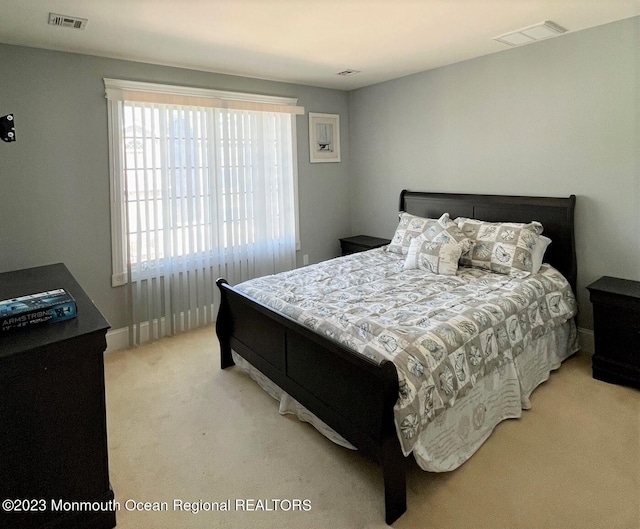 carpeted bedroom with multiple windows