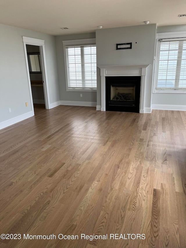 unfurnished living room featuring hardwood / wood-style floors