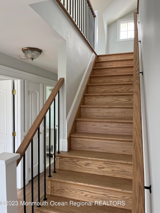 staircase featuring hardwood / wood-style flooring