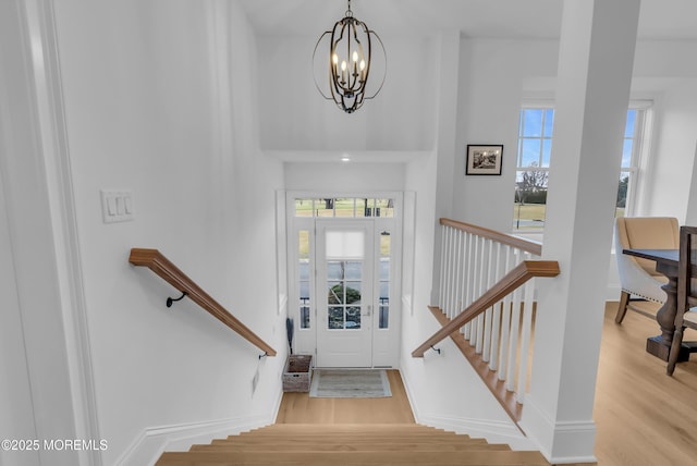 foyer with a chandelier, a healthy amount of sunlight, and light hardwood / wood-style floors