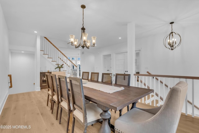 dining space with a chandelier and light hardwood / wood-style floors