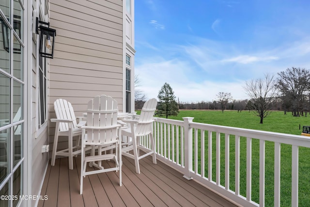 wooden terrace with a lawn