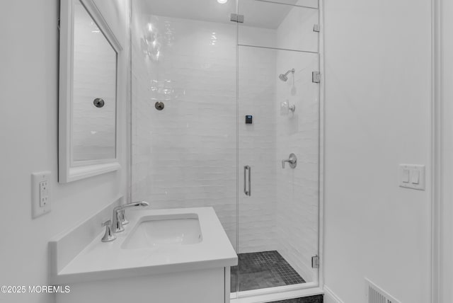 bathroom featuring vanity and an enclosed shower