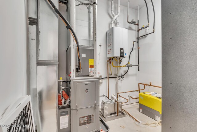 utility room with tankless water heater