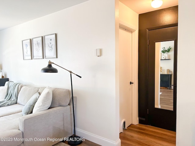 living area featuring baseboards and wood finished floors